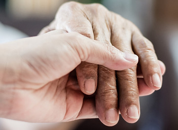 Parkinson and Alzheimer female senior elderly patient with caregiver in hospice care. Doctor hand with stethoscope check up older woman people. Old aging person seeing medical physician in hospital.